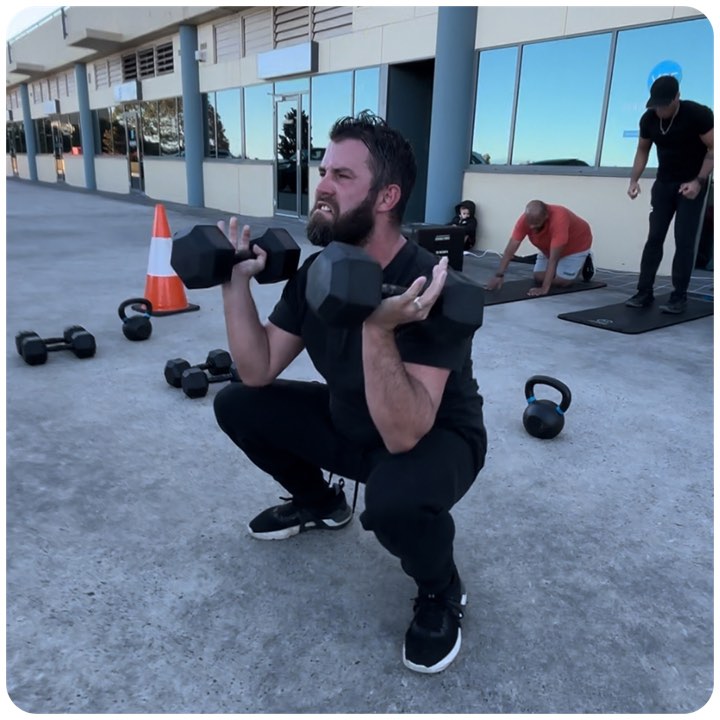 Dumbbell squat during an outdoor session